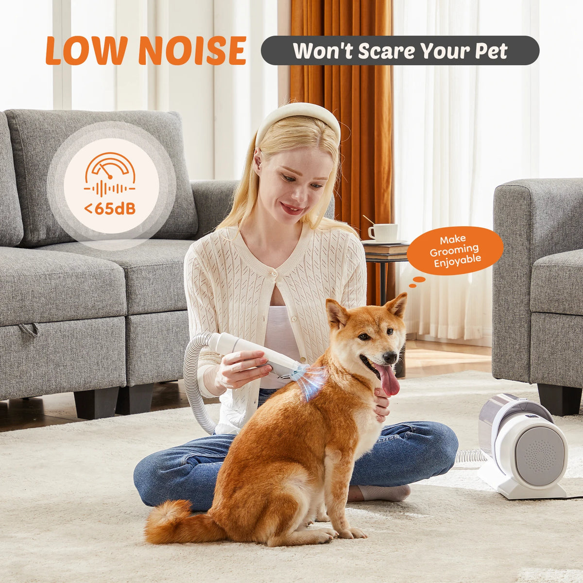 Woman grooming a dog with a low noise pet grooming tool in a living room.